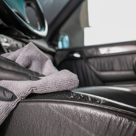 Detailing1 COLOURLOCK Leather Cleaner (Mild) — wiping down a black leather seat bolster with a microfibre towel